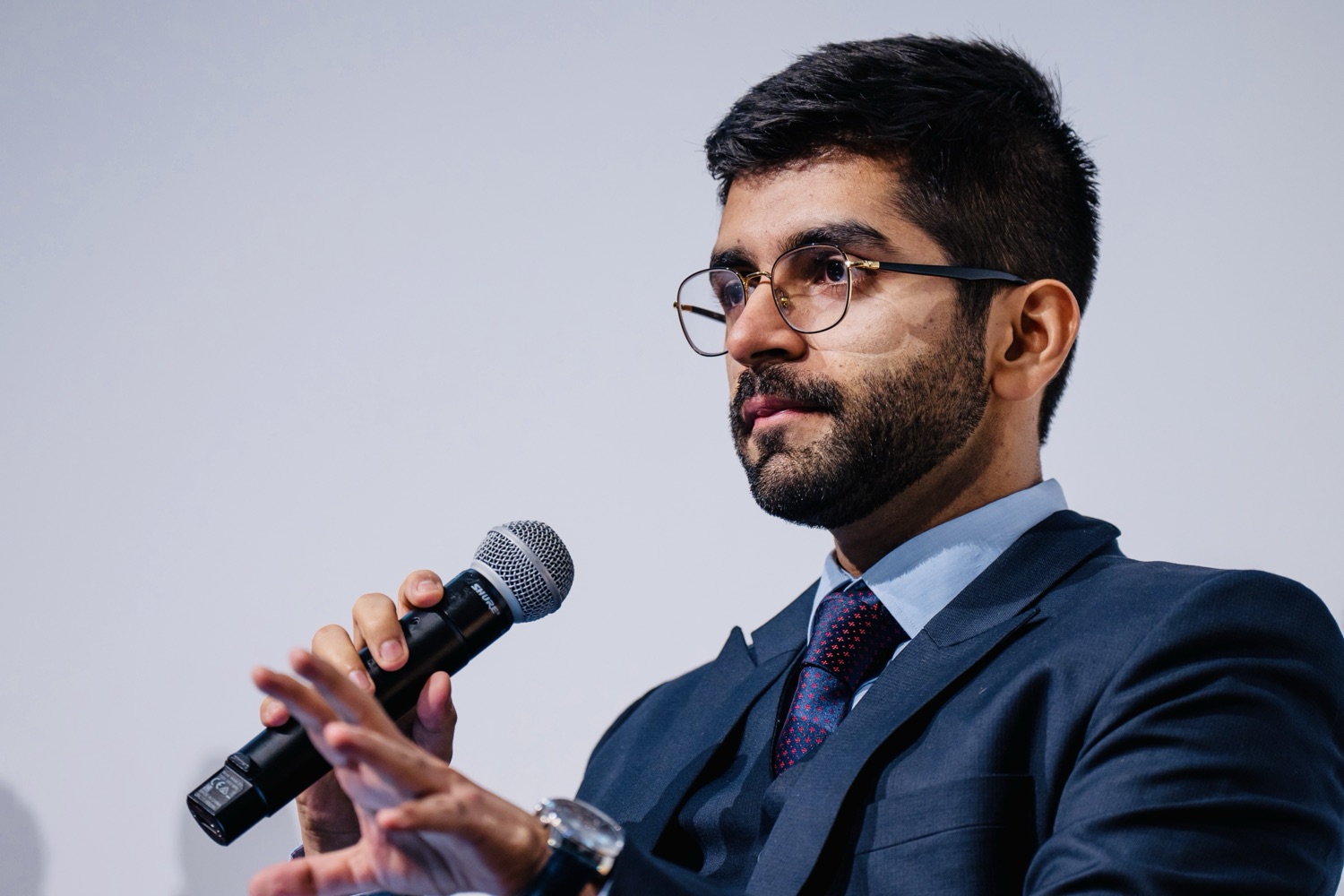 Kashish Aneja making a point with a microphone
