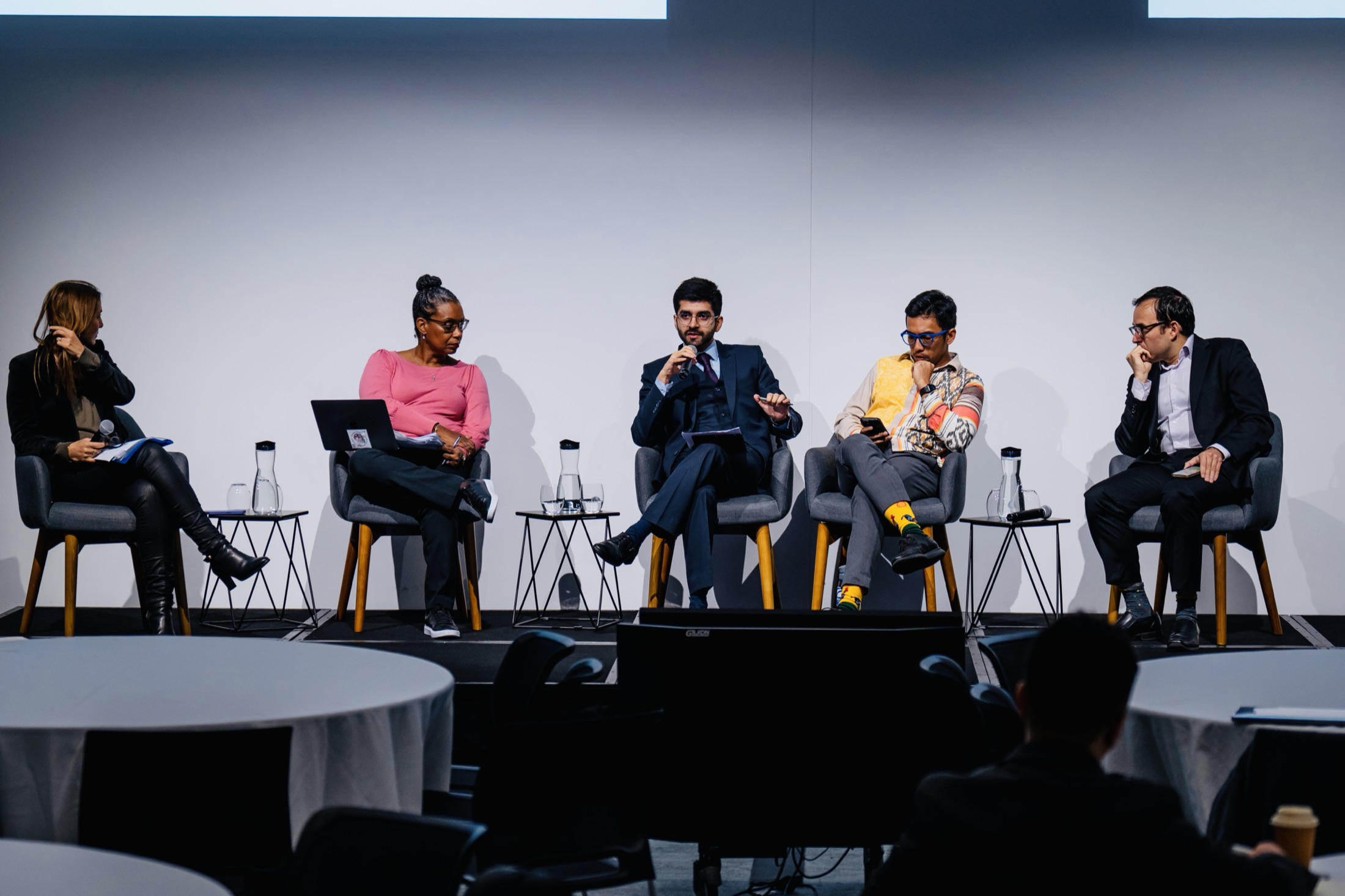 Five-person conference panel with Kashish Aneja speaking