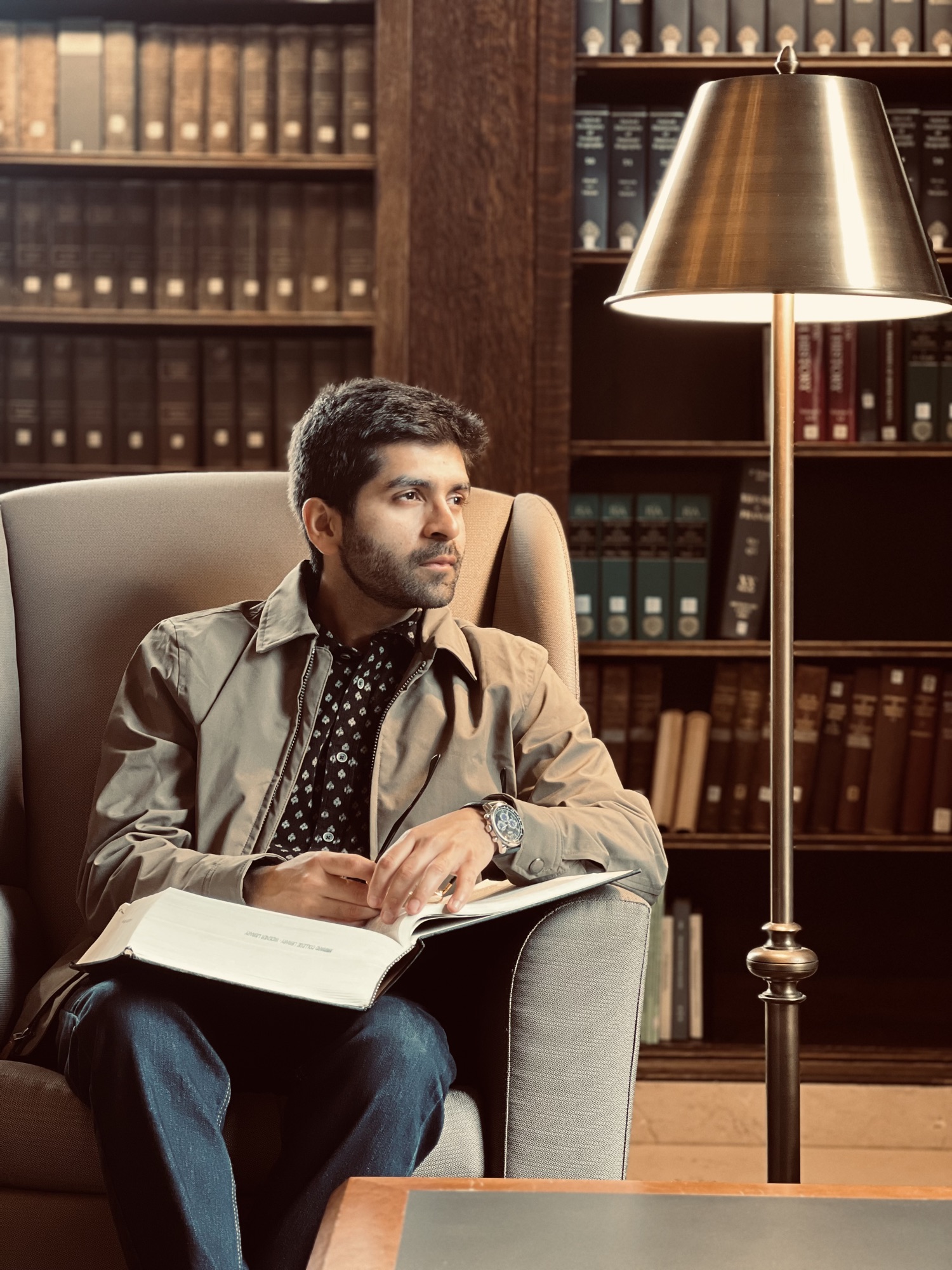 Kashish Aneja reading in a library
